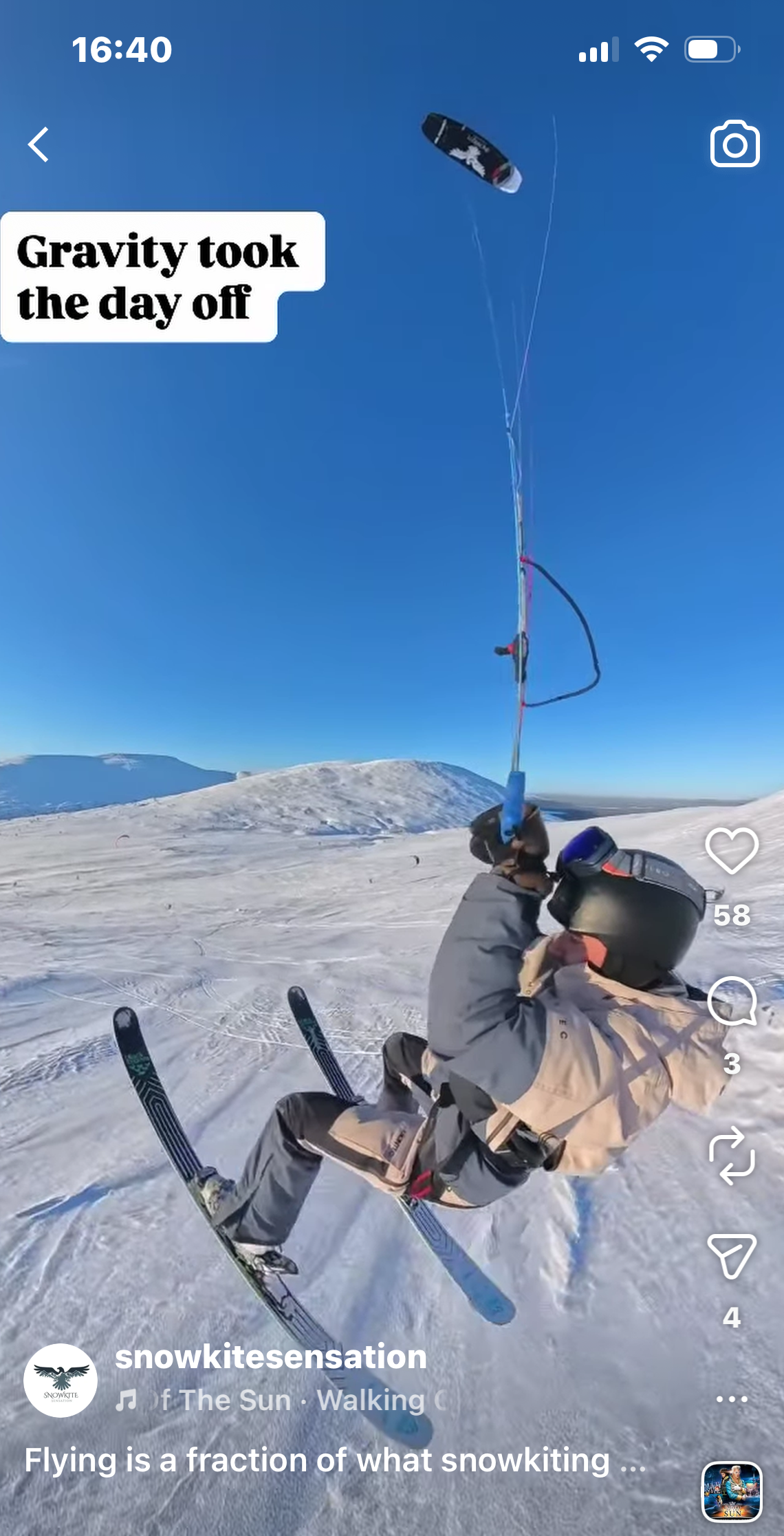 Snowkite rider flying over snowy landscape